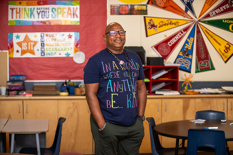 A man smiles in a classroom